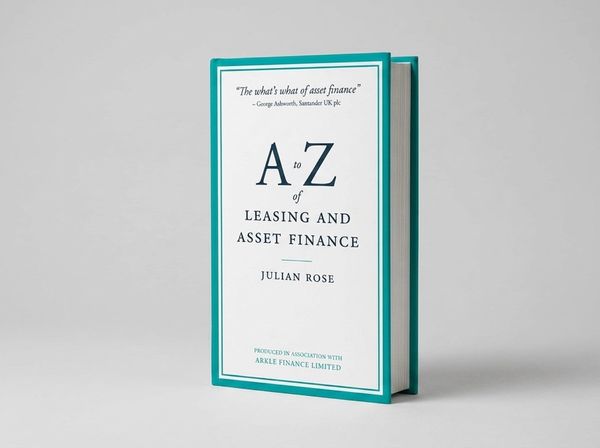 Business hardback on minimalist desk with notebook and pen in morning light