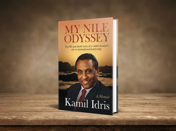 Open memoir beside a cup of tea and a framed family photograph