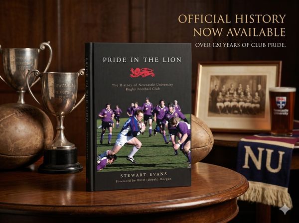 Sports book on a leather chair beside a worn match programme and a club scarf