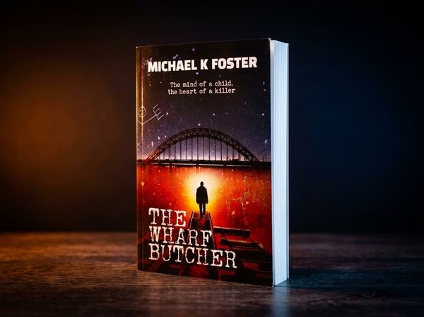 Dark thriller paperback on rain-streaked window sill with city lights behind